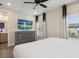 Bright bedroom with a TV, dresser, and modern wood-look flooring at 2920 On The Rocks Pt, Kissimmee, FL 34747