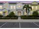 Charming townhouse with colorful facade, landscaped yard, and welcoming front entrance at 2920 On The Rocks Pt, Kissimmee, FL 34747