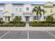 Charming townhouse with colorful facade, landscaped yard, and welcoming front entrance at 2920 On The Rocks Pt, Kissimmee, FL 34747