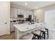 Modern kitchen with a large island, stainless steel appliances, and stylish bar stools at 2920 On The Rocks Pt, Kissimmee, FL 34747