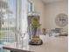 Close-up of a granite kitchen island with margarita maker and glasses ready for enjoyment at 2920 On The Rocks Pt, Kissimmee, FL 34747