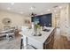 Modern kitchen with a large island and updated appliances, open to the living and dining areas at 2920 On The Rocks Pt, Kissimmee, FL 34747