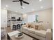 Spacious living room with an open-concept design connecting to a modern kitchen with bar seating at 2920 On The Rocks Pt, Kissimmee, FL 34747