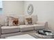 Relaxing living room featuring a plush sofa, decorative pillows, and a stylish mirror at 2920 On The Rocks Pt, Kissimmee, FL 34747