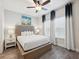 Spacious main bedroom with stylish furnishings, large window, and laminate flooring at 2920 On The Rocks Pt, Kissimmee, FL 34747