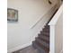 Staircase with wood steps and laminate flooring at 2920 On The Rocks Pt, Kissimmee, FL 34747