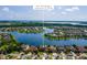 This aerial view features the home's location on a lake in its neighborhood at 3041 Boating Blvd, Kissimmee, FL 34746