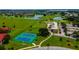 Aerial view of the community's amenities, featuring tennis courts, a golf course, and a clubhouse at 3041 Boating Blvd, Kissimmee, FL 34746