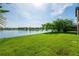 Picture of an immaculately kept waterfront backyard with lake views and verdant lawn at 3041 Boating Blvd, Kissimmee, FL 34746