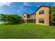Exterior view of a well-manicured lawn, waterfront access and screened in patio area for outdoor enjoyment at 3041 Boating Blvd, Kissimmee, FL 34746