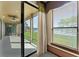 This sunroom has an amazing backyard view of a lake and lush tropical landscaping at 3041 Boating Blvd, Kissimmee, FL 34746