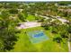 Community basketball court in a well-maintained park with green grass and mature trees at 3041 Boating Blvd, Kissimmee, FL 34746