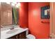Half bathroom with wood vanity, framed mirror, and a toilet at 3041 Boating Blvd, Kissimmee, FL 34746