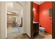Powder room featuring red walls, wood cabinetry and tile floors at 3041 Boating Blvd, Kissimmee, FL 34746