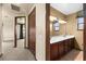 Bathroom with dual sinks, dark wood cabinets, and tile flooring at 3041 Boating Blvd, Kissimmee, FL 34746