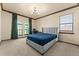 Bedroom with a gray upholstered bed, neutral carpet, and arched windows at 3041 Boating Blvd, Kissimmee, FL 34746