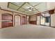 Carpeted bonus room featuring a wet bar, custom ceiling, and sliding glass doors at 3041 Boating Blvd, Kissimmee, FL 34746