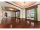 Formal dining room with hardwood floors, decorative ceiling, and elegant chandelier at 3041 Boating Blvd, Kissimmee, FL 34746
