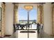 Dining area with views of the water features a modern chandelier and backyard access at 3041 Boating Blvd, Kissimmee, FL 34746