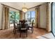 Inviting dining room boasts beautiful tile flooring, a stylish chandelier, and natural light at 3041 Boating Blvd, Kissimmee, FL 34746