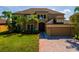 Exterior of home with front lawn and brick paver driveway at 3041 Boating Blvd, Kissimmee, FL 34746