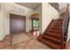 Inviting foyer with tile flooring, staircase, and view into the living area at 3041 Boating Blvd, Kissimmee, FL 34746
