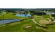 Scenic aerial view of the lush green golf course surrounded by lakes and lush landscaping at 3041 Boating Blvd, Kissimmee, FL 34746