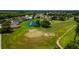 Aerial shot of a meticulously manicured golf course with a serene lake and beautiful trees at 3041 Boating Blvd, Kissimmee, FL 34746