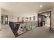 Hallway with iron-railed overlook and chandelier at 3041 Boating Blvd, Kissimmee, FL 34746