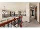 Spacious hallway with iron railing overlooking the lower level and plush neutral carpet at 3041 Boating Blvd, Kissimmee, FL 34746
