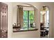 Interior view showcases an archway framing a window with a tropical view and adjacent dining area at 3041 Boating Blvd, Kissimmee, FL 34746