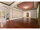 Open living space featuring hardwood floors, archways, and decorative wall panels at 3041 Boating Blvd, Kissimmee, FL 34746