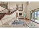 Spacious living room featuring an open floor plan with stairs, kitchen, and view of the lake at 3041 Boating Blvd, Kissimmee, FL 34746