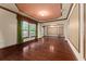 Formal living room featuring hardwood floors, custom wall trim, and large windows at 3041 Boating Blvd, Kissimmee, FL 34746
