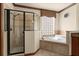 This main bathroom features a standalone shower and soaking tub with tiled accents at 3041 Boating Blvd, Kissimmee, FL 34746