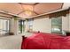 Bright main bedroom featuring a backyard view, carpet floors, and lots of natural light at 3041 Boating Blvd, Kissimmee, FL 34746