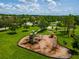 An elevated view of a vibrant playground featuring swings and slides for hours of fun at 3041 Boating Blvd, Kissimmee, FL 34746