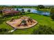 Community playground with swings and slides, set against a backdrop of a serene lake at 3041 Boating Blvd, Kissimmee, FL 34746