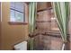 Shower with a glass door, tiled walls, and a window for natural light at 3041 Boating Blvd, Kissimmee, FL 34746
