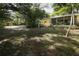 Lush green backyard with screened porch, ideal for enjoying the outdoors at 317 White Oak Dr, Altamonte Springs, FL 32701