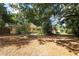 Large, shady backyard showcasing the home's exterior and mature trees at 317 White Oak Dr, Altamonte Springs, FL 32701