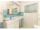 Bathroom with blue accents, featuring a sink, vanity, and coordinated accessories at 317 White Oak Dr, Altamonte Springs, FL 32701