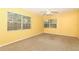 Bright bedroom with neutral carpet, ceiling fan, and two large windows at 317 White Oak Dr, Altamonte Springs, FL 32701