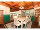 Charming dining area with a large window, view to the kitchen and wood-beam ceiling at 317 White Oak Dr, Altamonte Springs, FL 32701