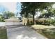 The home includes a detached two-car garage with matching yellow siding and a spacious concrete driveway at 317 White Oak Dr, Altamonte Springs, FL 32701