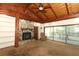 Comfortable living room featuring a wood-beamed ceiling, stone fireplace, and a sliding glass door at 317 White Oak Dr, Altamonte Springs, FL 32701
