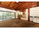 Open-concept living room with exposed wood beams, a wet bar area, and access to an outdoor patio at 317 White Oak Dr, Altamonte Springs, FL 32701