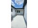 View of a rear patio with access door and windows to the home at 331 N Dollins Ave, Orlando, FL 32805