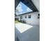 View of a back yard with a concrete patio, grassy area, and partial fence at 331 N Dollins Ave, Orlando, FL 32805