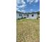 Full back yard view with grass and fenced area in the background at 331 N Dollins Ave, Orlando, FL 32805